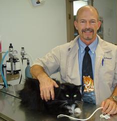A man and his cat in the vet 's office.